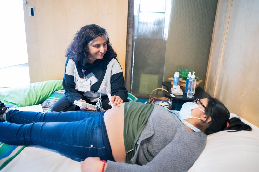 midwife examines a pregnant patient